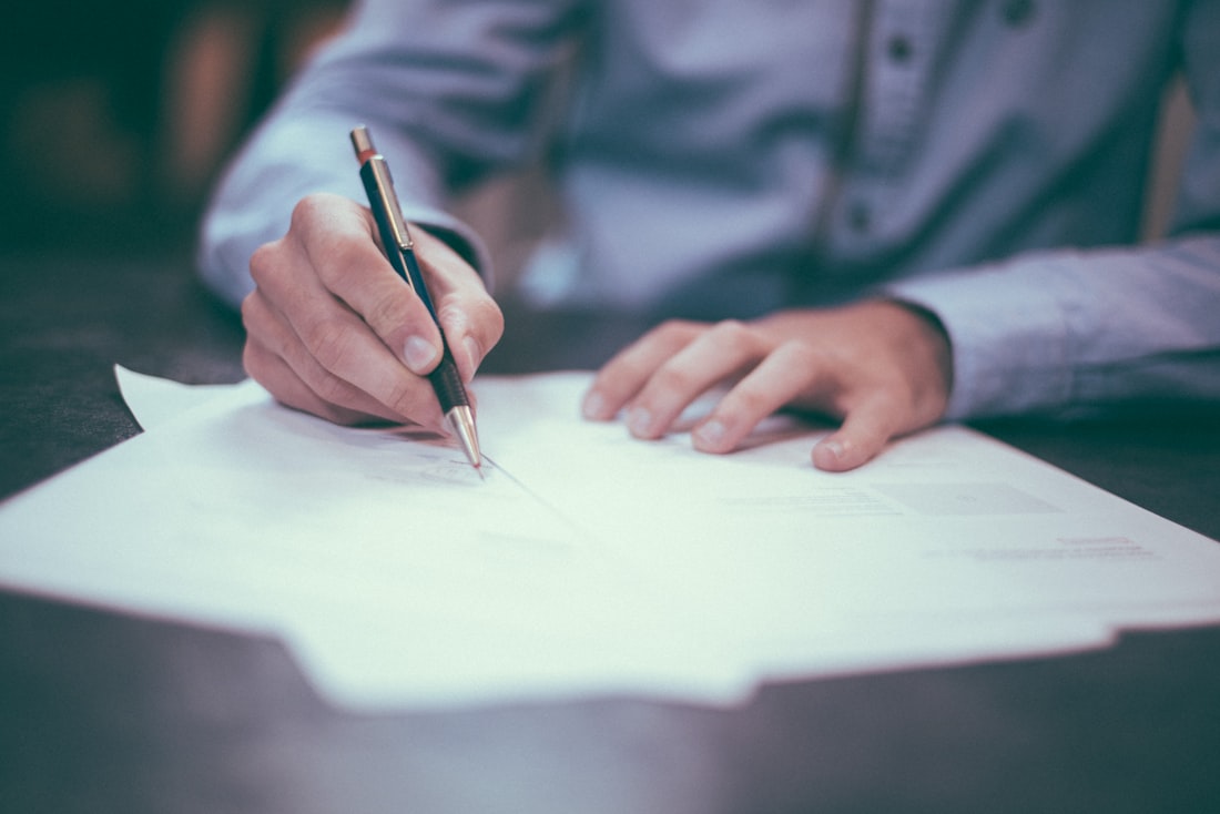 A document being signed at a desk